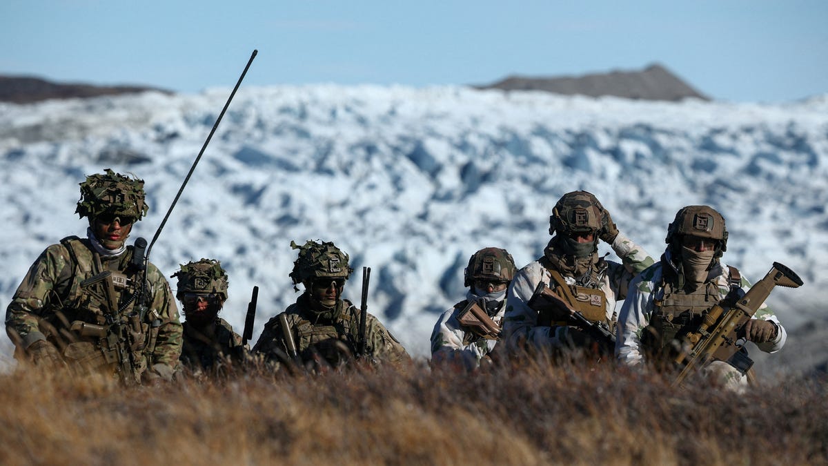 Members of the Danish armed forces practice looking for potential threats during military drills in Kangerlussuaq, Greenland, on Sept. 17, 2025.