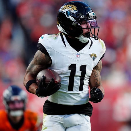 Jacksonville Jaguars wide receiver Parker Washington (11) makes a catch for a touchdown against the Denver Broncos during the second half at Empower Field at Mile High in Denver on Dec. 21, 2025.