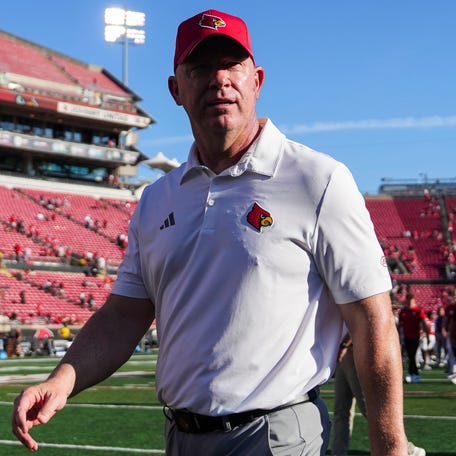 Louisville football coach Jeff Brohm walks off the field after his team's defeat of Eastern Kentucky at L&N Federal Credit Union Stadium.