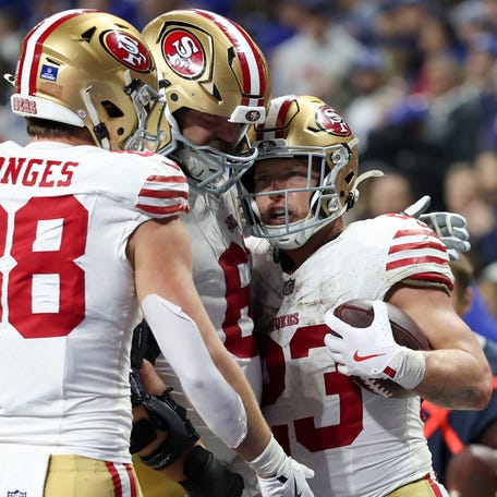 Dec 22, 2025; Indianapolis, Indiana, USA; San Francisco 49ers running back Christian McCaffrey (23) celebrates after scoring a touchdown against the Indianapolis Colts with tight end Jake Tonges (88) and fullback Kyle Juszczyk (44) in the fourth quarter of the game at Lucas Oil Stadium. Mandatory Credit: Trevor Ruszkowski-Imagn Images