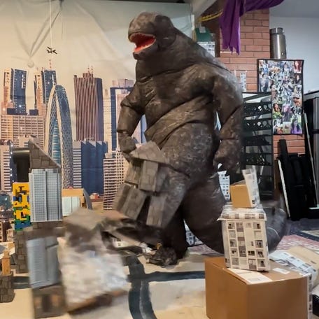 Godzilla fan relieves stress by destroying city made of cardboard and Legos.