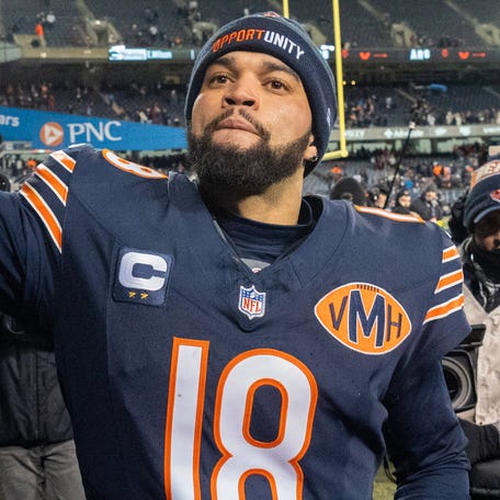 Chicago Bears quarterback Caleb Williams high fives fans after defeating the Green Bay Packers during overtime at Soldier Field on Dec. 20, 2025.