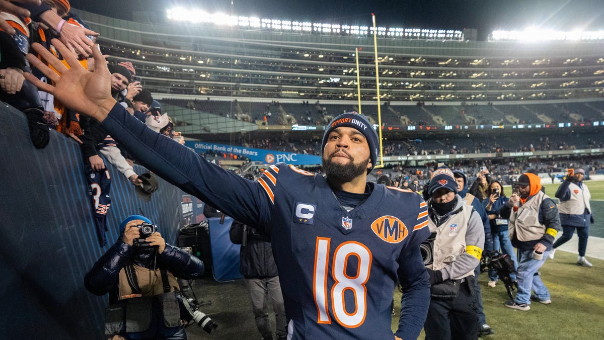 Chicago Bears quarterback Caleb Williams high fives fans after defeating the Green Bay Packers during overtime at Soldier Field on Dec. 20, 2025.