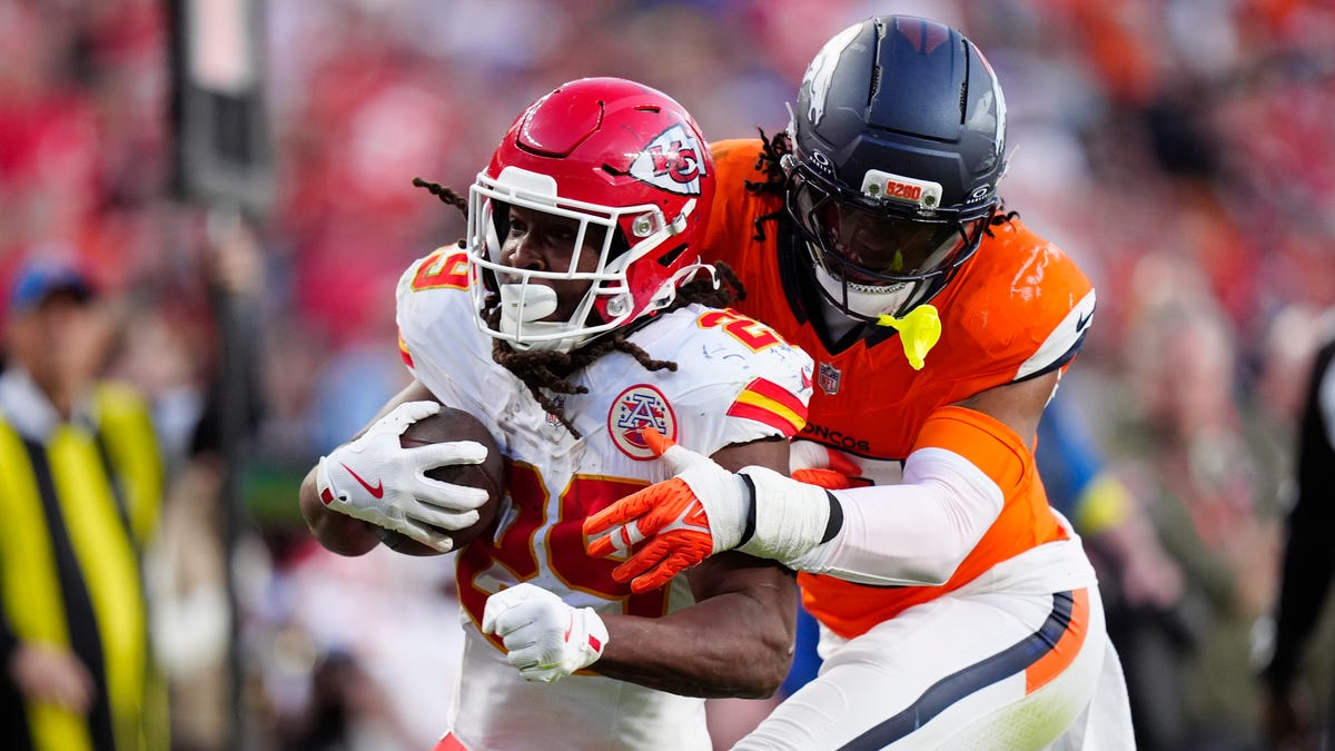 Denver Broncos linebacker Nik Bonitto (15) tackles Kansas City Chiefs running back Kareem Hunt (29) during a game at Empower Field at Mile High in Denver on Nov. 16, 2025.