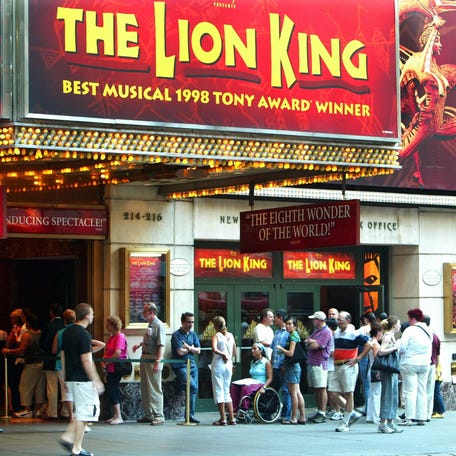People wait for tickets outside of the Broadway musical "The Lion King" on Aug. 15, 2003, in New York City.