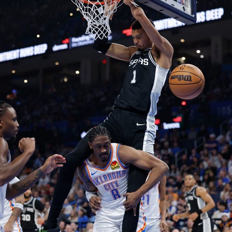 San Antonio Spurs forward Victor Wembanyama (1) dunks over Oklahoma City Thunder guard Jalen Williams during a game on Dec. 25, 2025.