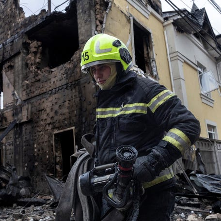 A firefighter walks at the site where a Russian drone struck a residential building during a night of Russian drone and missile attacks, amid Russia's attack on Ukraine, in Kyiv, Ukraine, Dec. 27, 2025.