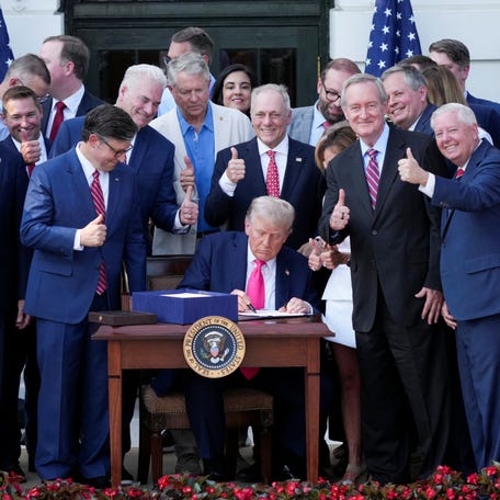 U.S. President Donald Trump signs a sweeping spending and tax legislation, known as the "One Big Beautiful Bill Act," during a picnic with military families to mark Independence Day, at the White House in Washington, D.C., U.S., July 4, 2025. REUTERS/Ken Cedeno
