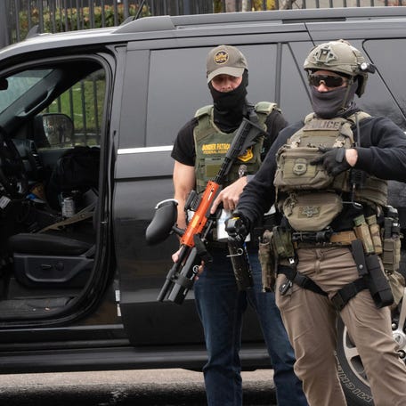 An Immigration and Customs Enforcement agent points to his badge during a traffic stop in Springfield, Oregon, on Nov.19, 2025.