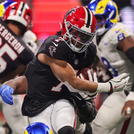 Atlanta Falcons running back Bijan Robinson runs the ball against the Los Angeles Rams in the first quarter at Mercedes-Benz Stadium on Dec. 29, 2025.