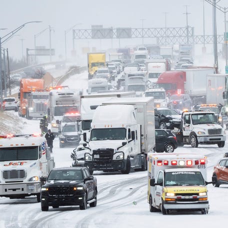 Rescue workers and tow trucks work to help people at a multiple-car pileup on northbound I-75 near Highland Park, Michigan, after snow squalls and strong winds made driving conditions dangerous on the roadways on Monday, Dec. 29, 2025.