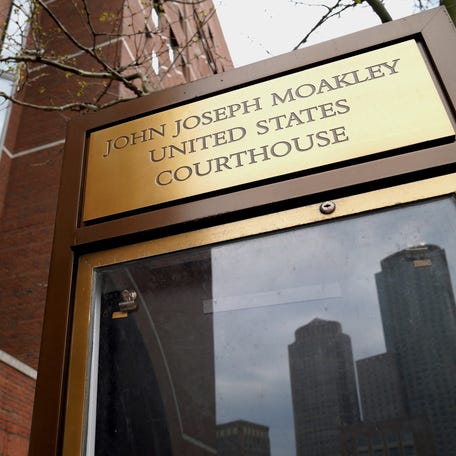 The skyline of Boston is reflected in a sign for the federal courthouse, where a judge is considering whether to continue to block immigration authorities from taking action against Boston University student Huadan Zheng after the administration of U.S. President Donald Trump removed her records from a database used to confirm compliance with student visa conditions, in Boston, Massachusetts, U.S., April 25, 2025.   REUTERS/Amanda Sabga