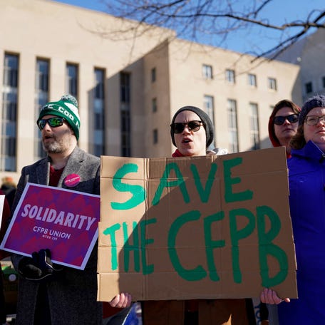 Consumer Financial Protection Bureau (CFPB) workers rally on the day of a hearing on March 3, 2025 in a case on the Trump administration's mass firings of CFPB workers, outside the U.S. District Court in Washington, D.C.