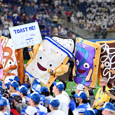 The Pop-Tarts mascots celebrate with the BYU Cougars following the 2025 Pop-Tarts Bowl between the BYU Cougars and the Georgia Tech Yellow Jackets at Camping World Stadium on December 27, 2025 in Orlando, Florida. The BYU Cougars defeated the Georgia Tech Yellow Jackets 25-21.