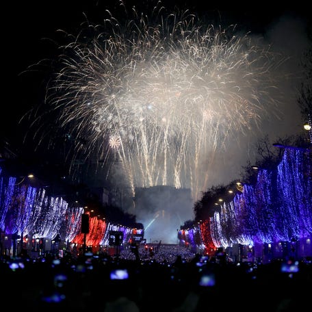 Fireworks explode in the sky over the Arc de Triomphe, on the Place de l'Etoile, in central Paris, to celebrate the New Year, just after midnight on Jan. 1, 2026.