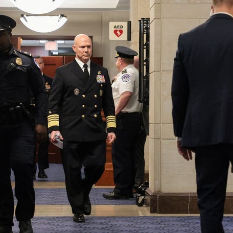 U.S. Navy Admiral Frank "Mitch" Bradley walks in a hallway, as he departs a classified briefing for leaders of the Senate Armed Services Committee on U.S. strikes against Venezuelan boats suspected of smuggling drugs, on Capitol Hill in Washington, D.C. on Dec. 4, 2025.