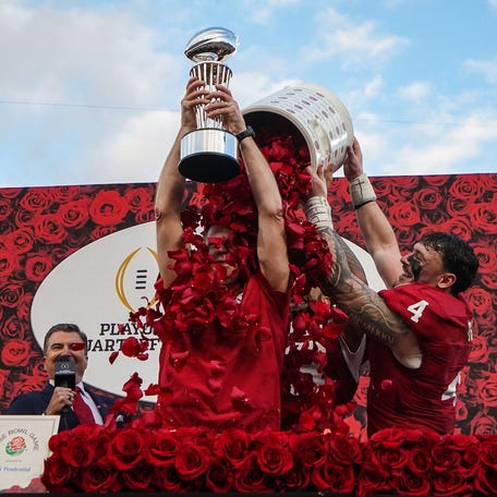 Curt Cignetti celebrates by holding Rose Bowl trophy as he has rose petals poured on him after Indiana's dominant win over Alabama in the CFP quarterfinals.