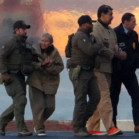 DEA agents move captured Venezuelan President Nicolas Maduro and his wife Cilia Flores out of a helicopter, as Nicolas Maduro heads towards the Daniel Patrick Manhattan United States Courthouse for an initial appearance to face U.S. federal charges including narco-terrorism, conspiracy, drug trafficking, money laundering and others in New York City, U.S., January 5, 2026. REUTERS/Adam Gray