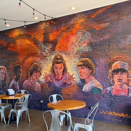 Murals of "Stranger Things" characters adorn the walls of a building on Jackson's square, which served as the setting of downtown Hawkins.