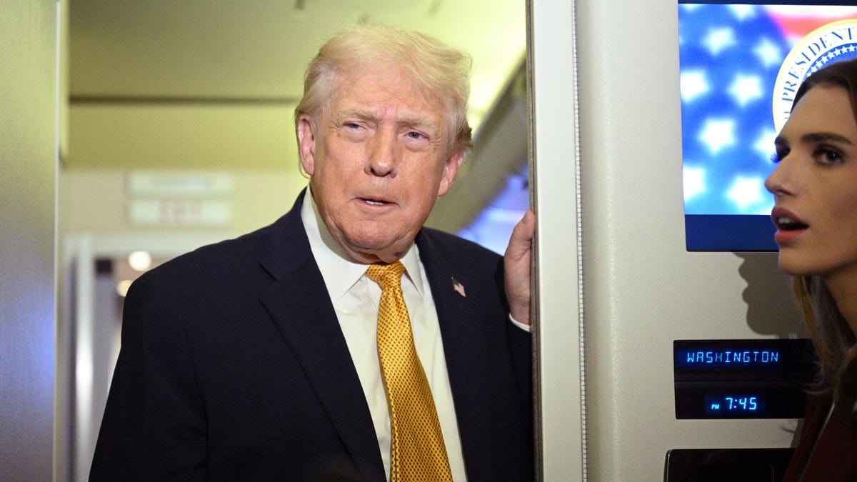 President Donald Trump speaks with reporters aboard Air Force One on his way back to Washington, DC, on Jan. 4, 2026.