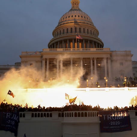 An explosion caused by a police munition is seen while supporters of President Donald Trump riot in front of the U.S. Capitol in Washington, DC, on Jan. 6, 2021.