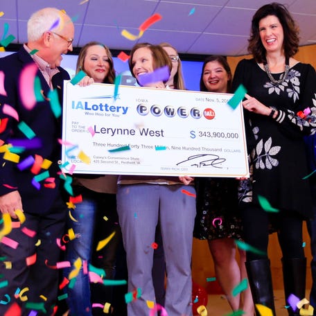 Lerynne West steps forward to claim a $343.9 million Powerball jackpot, the largest prize in Iowa history, Nov. 5, 2018.