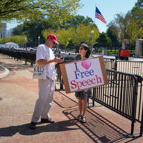 Demonstrators hold signs in support of free speech outside the White House in Washington, D.C., U.S., September 19, 2025.