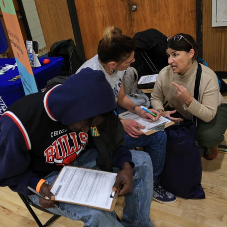 Visitors fill in job applications at the annual New Bedford Connect conference held at the New Bedford YMCA.