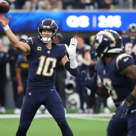 Dec 27, 2025; Inglewood, California, USA; Los Angeles Chargers quarterback Justin Herbert (10) passes the ball over against the Houston Texans during the second half at SoFi Stadium. Mandatory Credit: Kiyoshi Mio-Imagn Images