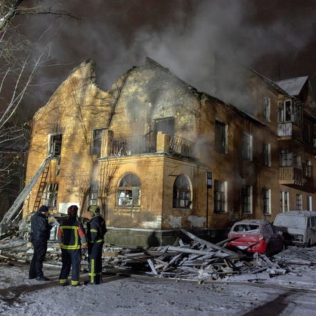 Firefighters stand in front of a residential building that was hit during Russian drone and missile attacks in Kyiv, Ukraine, on Jan 9, 2026.