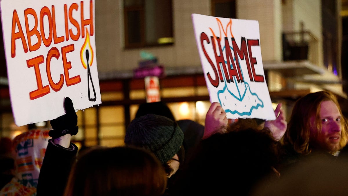 Demonstrators hold posters outside the Portland ICE facility while protesting, after U.S. federal agents shot two people in Portland, Oregon, U.S., January 8, 2026.