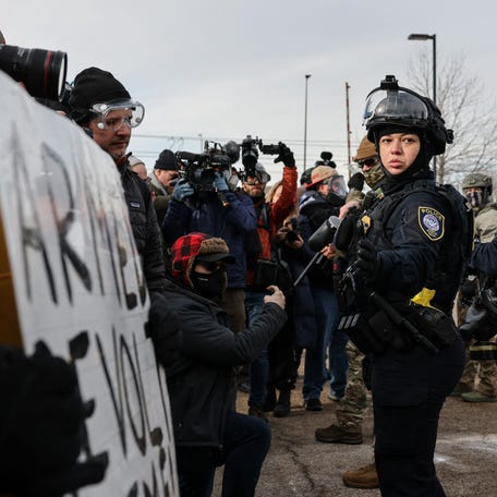 Federal Protective Service (FPS) agents stand guard outside the Bishop Henry Whipple Federal Building during a protest against increased immigration enforcement, after a U.S. Immigration and Customs Enforcement (ICE) agent fatally shot Renee Nicole Good, in Minneapolis, Minnesota, U.S., January 9, 2026. REUTERS/Tyrone Siu