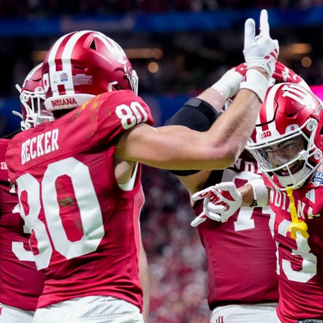 Indiana Hoosiers wide receiver Charlie Becker (80) celebrates with teammates including Indiana Hoosiers wide receiver Elijah Sarratt (13) on after making a catch for a touchdown Friday, Jan. 9, 2026, during the Peach Bowl and semifinal game of the College Football Playoff against the Oregon Ducks at Mercedes-Benz Stadium in Atlanta.