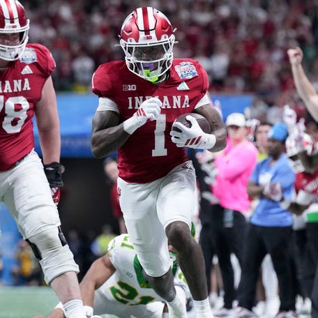Indiana running back Roman Hemby (1) rushes down the sideline against Oregon during the College Football Playoff semifinals in the 2026 Peach Bowl at Mercedes-Benz Stadium in Atlanta.