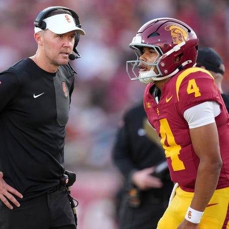 Aug 30, 2025; Los Angeles, California, USA; Southern California Trojans head coach Lincoln Riley talks with Southern California Trojans quarterback Husan Longstreet (4) in the second half against the Missouri State Bears at United Airlines Field at Los Angeles Memorial Coliseum. Mandatory Credit: Kirby Lee-Imagn Images