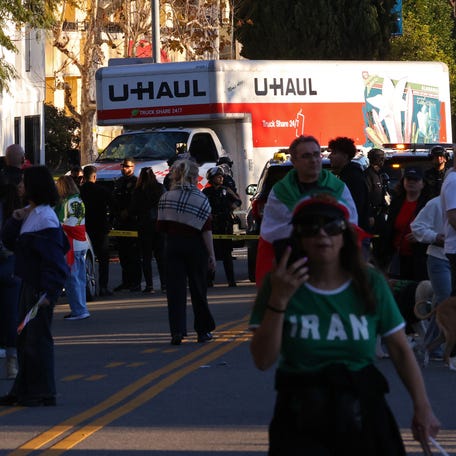 People walk near a U-Haul truck near a crowd during an anti-Iranian regime rally in Los Angeles on Jan. 11, 2026