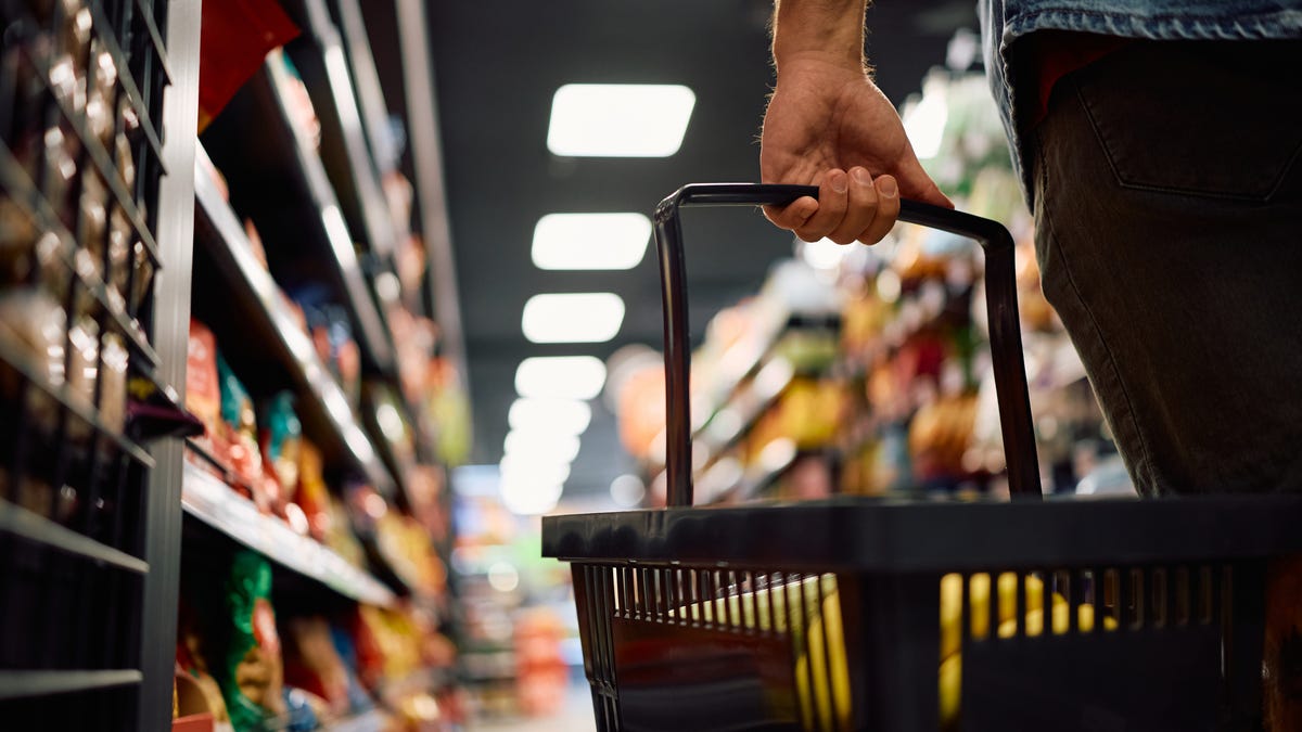 Close up of man buying groceries in supermarket. Copy space.