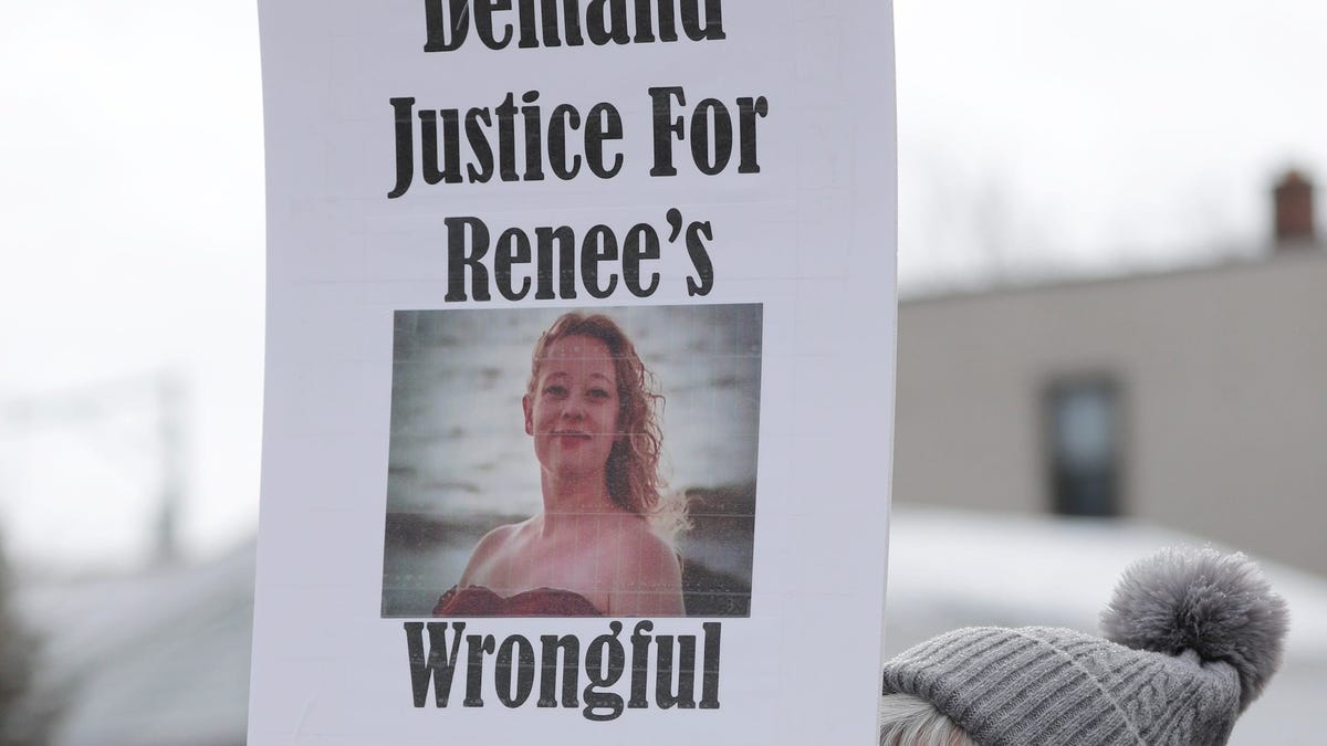 A woman holds a sign demanding justice for the death by ICE of Renee Good during a rally against ICE at 14th and Erie, Saturday, January 10, 2026, in Sheboygan, Wisconsin.