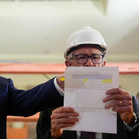 President Donald Trump and Federal Reserve Chair Jerome Powell reviews numbers during a tour of the renovation of the Federal Reserve Board building in Washington, DC, on July 24, 2025.
