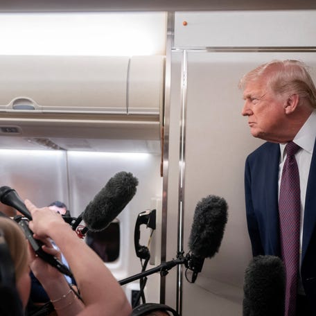 U.S. President Donald Trump speaks with members of the media aboard Air Force One en route from Florida to Joint Base Andrews, Maryland, U.S., January 11, 2026.