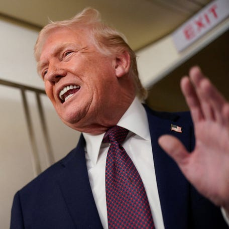 President Donald Trump speaks with reporters aboard Air Force One en route from Florida to Washington, DC, on Jan. 11, 2026.