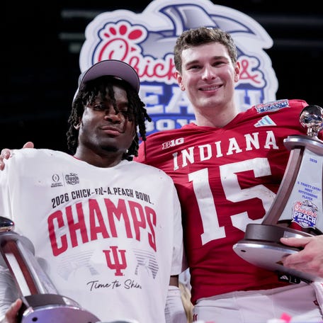 Indiana Hoosiers defensive back D'Angelo Ponds (5) and Indiana Hoosiers quarterback Fernando Mendoza (15) pose for photographs Friday, Jan. 9, 2026, after defeating the Oregon Ducks in the Peach Bowl and semifinal game of the College Football Playoff at Mercedes-Benz Stadium in Atlanta.