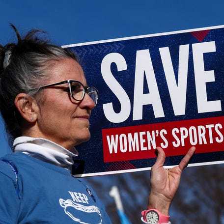 A protester against transgender athletes competing in women's sports joins a rally outside the U.S. Supreme Court in Washington, DC, on Jan. 13, 2026.