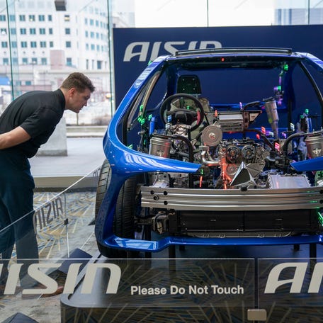 Kevin Bicknell, a project manager for Bosch, of Canton, takes a look at a vehicle at the AISIN display during Media Day at the 2026 Detroit Auto Show held at Huntington Place in Detroit on Wednesday, Jan. 14, 2026.