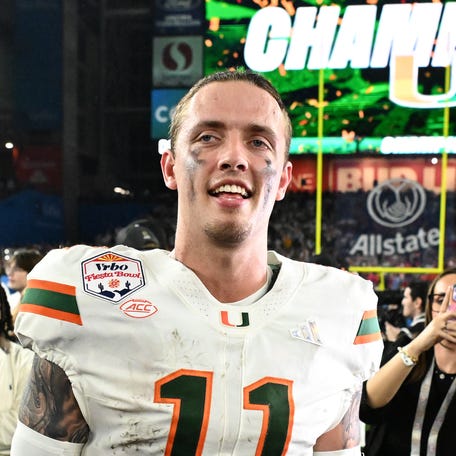 GLENDALE, ARIZONA - JANUARY 08: Carson Beck #11 of the Miami Hurricanes reacts after the game against the Ole Miss Rebels during the 2025 College Football Playoff Semifinal at the VRBO Fiesta Bowl at State Farm Stadium on January 08, 2026 in Glendale, Arizona. The Hurricanes defeated the Rebels 31-27. (Photo by Norm Hall/Getty Images)