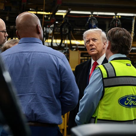 President Donald Trump speaks with Jim Farley, CEO of Ford and Corey Williams, Ford River Rouge Plant Manager, as he visits a Ford production center in Dearborn, Michigan, on Jan. 13, 2026.