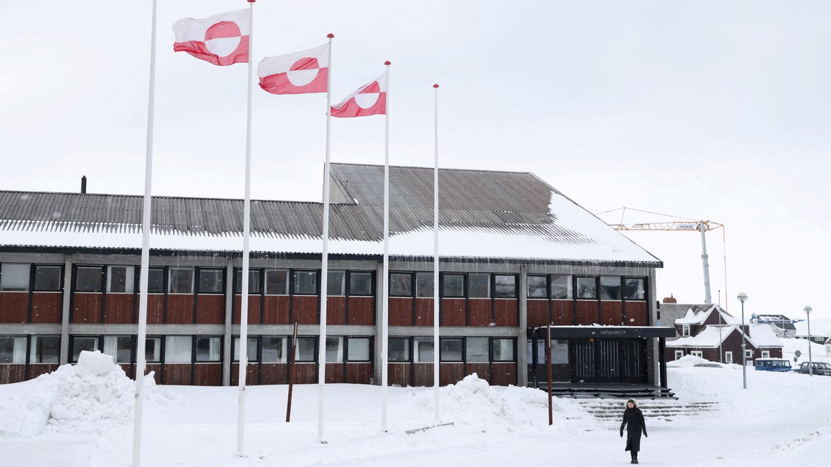 FILE PHOTO: A woman walks past Greenland's parliament Inatsisartut in Nuuk, Greenland, March 28, 2025. REUTERS/Leonhard Foeger/File Photo