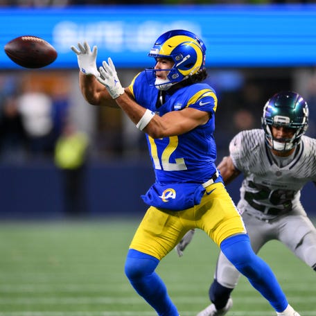 Dec 18, 2025; Seattle, Washington, USA; Los Angeles Rams wide receiver Puka Nacua (12) makes a catch against Seattle Seahawks cornerback Josh Jobe (29) in overtime at Lumen Field.