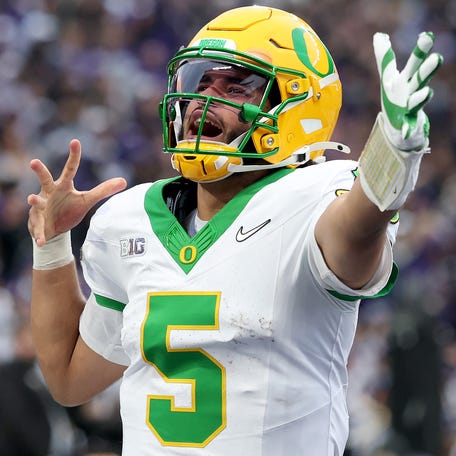 Dante Moore #5 of the Oregon Ducks celebrates a touchdown during the second half against the Washington Huskies at Husky Stadium on November 29, 2025 in Seattle, Washington.