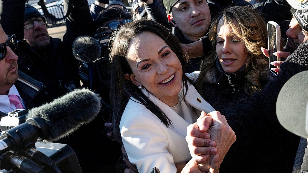 Venezuelan opposition leader Maria Corina Machado greets supporters outside the White House following a meeting with U.S. President Donald Trump in Washington, D.C., U.S., January 15, 2026.